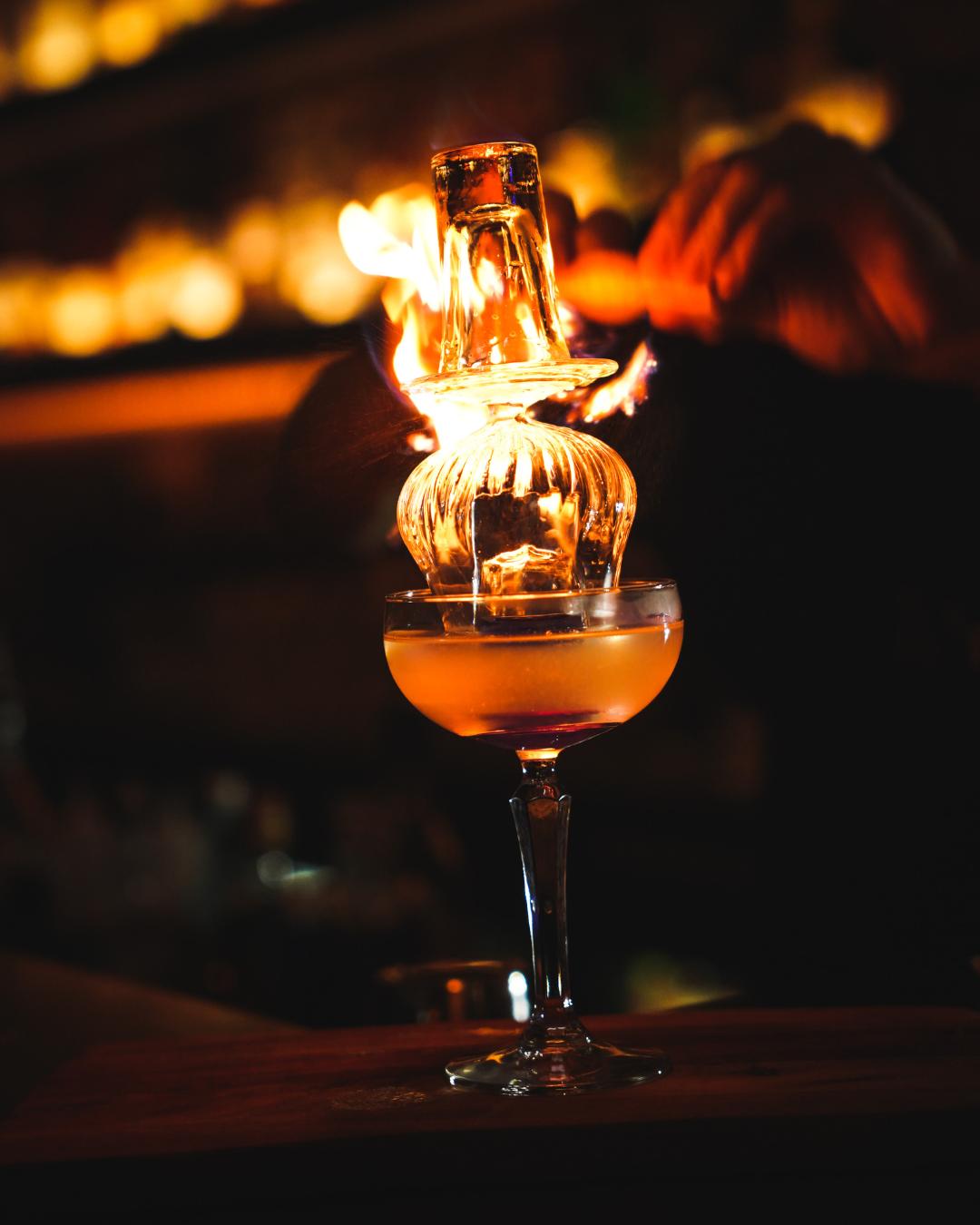 A warm Adelaide restaurant scene showing guests at a well-lit table with drinks and food